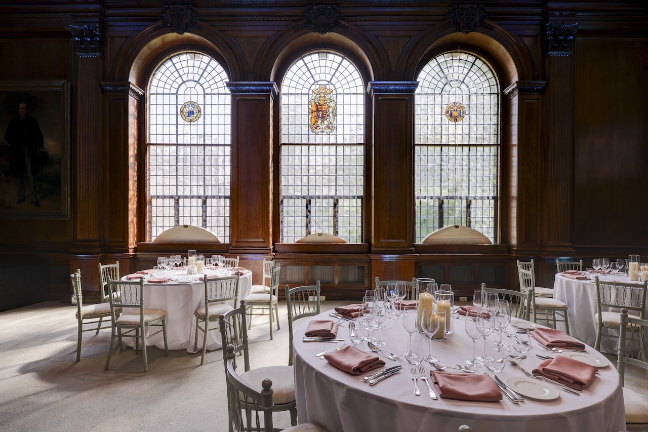 Surveyors House- Lecture hall room set up with stain glass window in the back